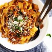 ragu sauce with pasta served in a white bowl