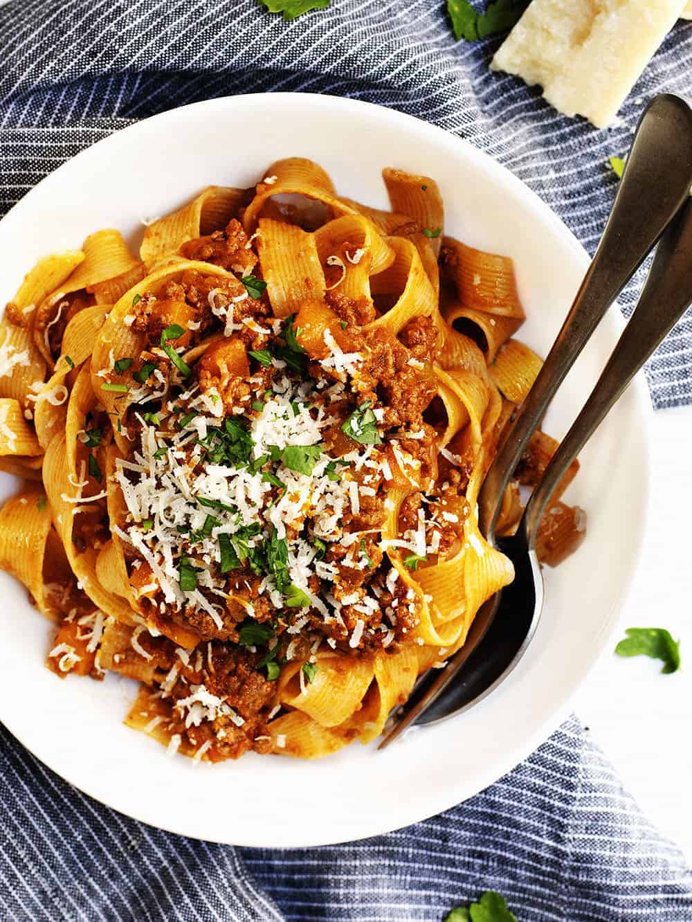 ragu sauce with pasta in a white bowl