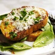 savory french toast served with mixed baby greens on a white plate