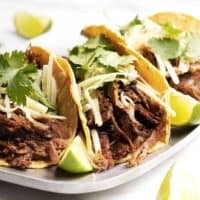 Pork Carnitas Tacos served on a metal platter