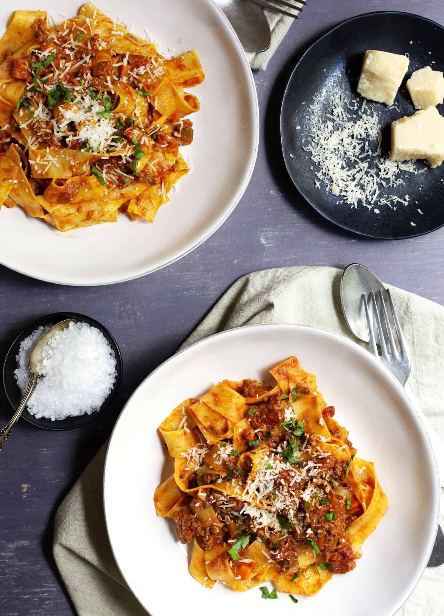 Bolognese Sauce served with pappardelle in shallow white bowls