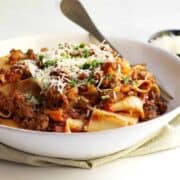 Bolognese Sauce with pappardelle served in a shallow white bowl