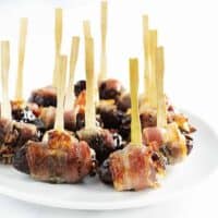 Bacon Wrapped Dates served on a white platter