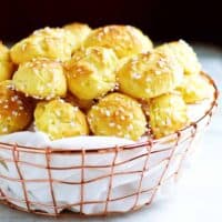 Homemade-Chouquettes-French-Pastry-Sugar-Puffs served in a wire basked featured