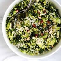 Kale and Brussels Sprouts Salad served in a white bowl