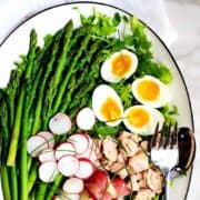 Asparagus-Nicoise-Salad on a white platter featured