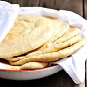 Pita-Bread served in a bowl wrapped in white cloth featured