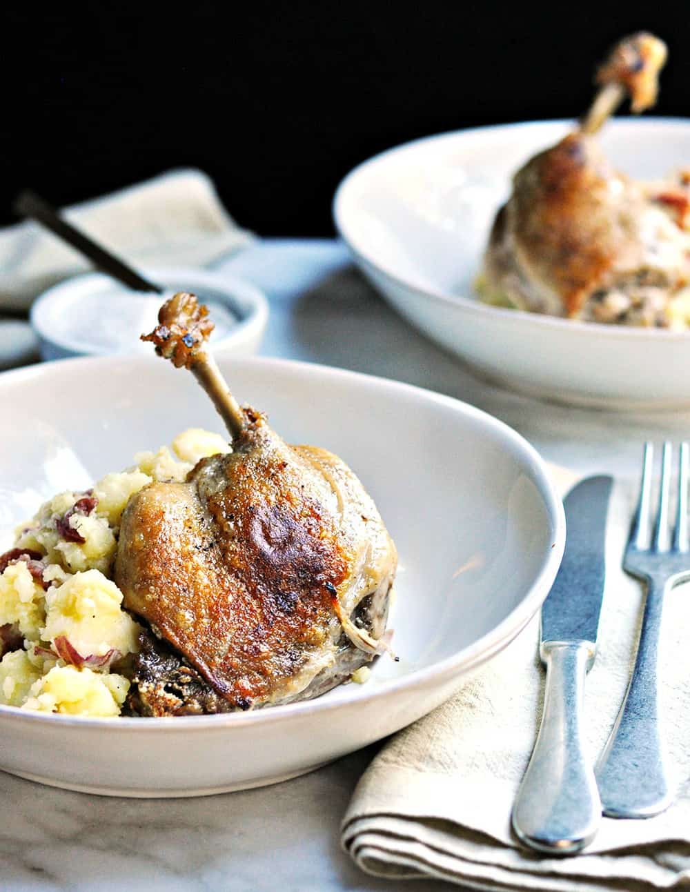 Easy Duck Confit Served in Shallow Bowls with mashed potatoes