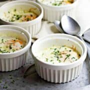 Baked Eggs in white ramekins featured