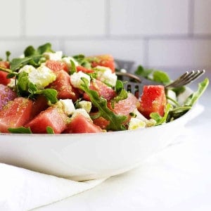 Watermelon and Arugula Salad with Feta Cheese served in a white ceramic bowl