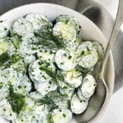 Creamy Cucumber Salad served in a shallow white bowl