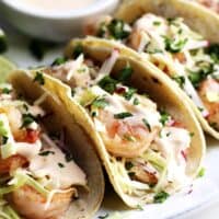 Shrimp Tacos served on a platter with shrimp taco sauce