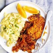 Sweet Potato Hash Browns with scrambled eggs on a white plate