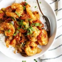 Shrimp Creole over rice served in a white bowl square image
