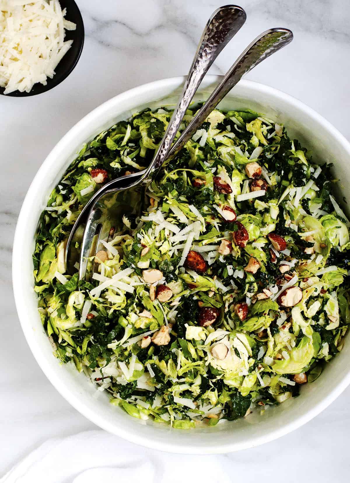 Kale and Brussels Sprout Salad served in a white bowl