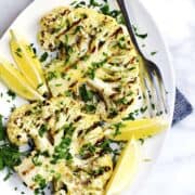Grilled Cauliflower Steaks on a white oval platter