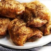 Grilled Chicken Thighs on a white plate
