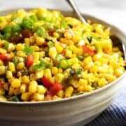 Corn Maque Choux served in a gray ceramic bowl