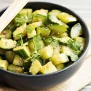 Chinese Cucumber Salad served in a charcoal bowl with chopsticks