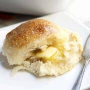 Brioche Roll served on a white plate with butter