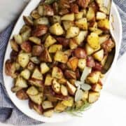 Italian Roasted Potatoes served on an oval white platter