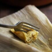 pressing a fork into Vegetarian Tamale with Green Chiles and Cheese