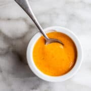 Sriracha Aioli served in a white bowl with a spoon