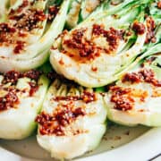 Grilled Baby Bok Choy on a white platter.