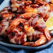 Grilled Bacon Wrapped Shrimp served on a stainless steel platter.