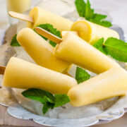 Pina Colada Popsicles stacked on a silber tray.