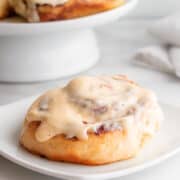 Brioche Cinnamon Roll served on a white square plate.