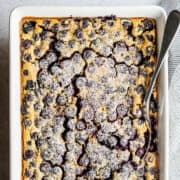 Blueberry Clafoutis in a white baking dish ready to serve.