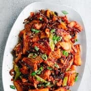 Korean Pork Belly served on a brushed metal platter.