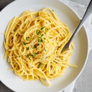 Garlic Butter Noodles served in a white bowl and photographed from above.