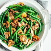Green Beans and Mushrooms served in a large white bowl photographed from above.