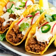 Lamb Tacos served on a steel platter.