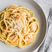 Shrimp Carbonara served in a white bowl and photographed from the top..