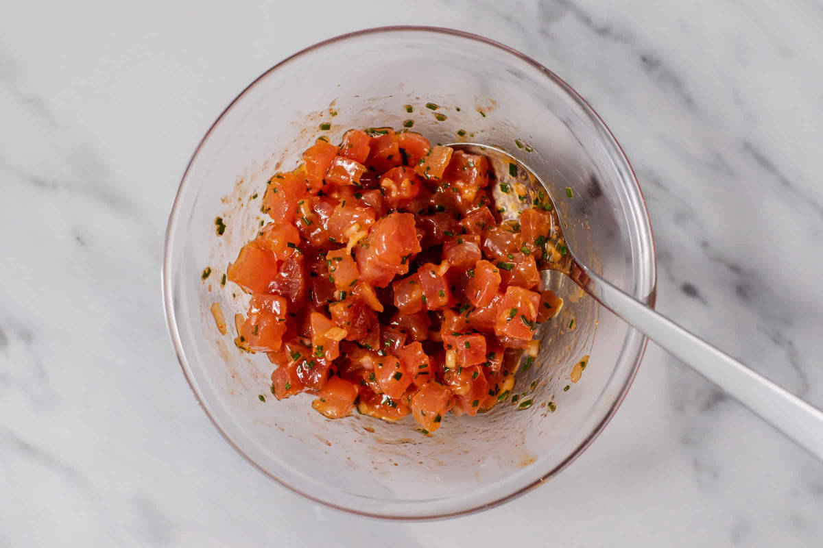 diced tuna and avocado tossed with dressing in bowl