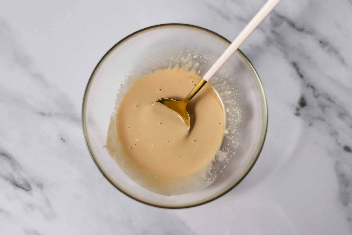 ponzu sauce and mayonnaise mixture with spoon in glass bowl