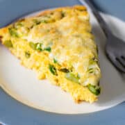 Asparagus Frittata wedge served on a white and gray plate.