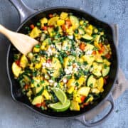 Calabacitas served in a cast iron skillet and photographed from overhead.
