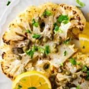 Cauliflower Piccata served on a white oval platter photographed from overhead.