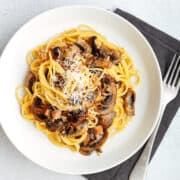 Mushroom Carbonara served in a shallow white bowl and photographed from overhead.