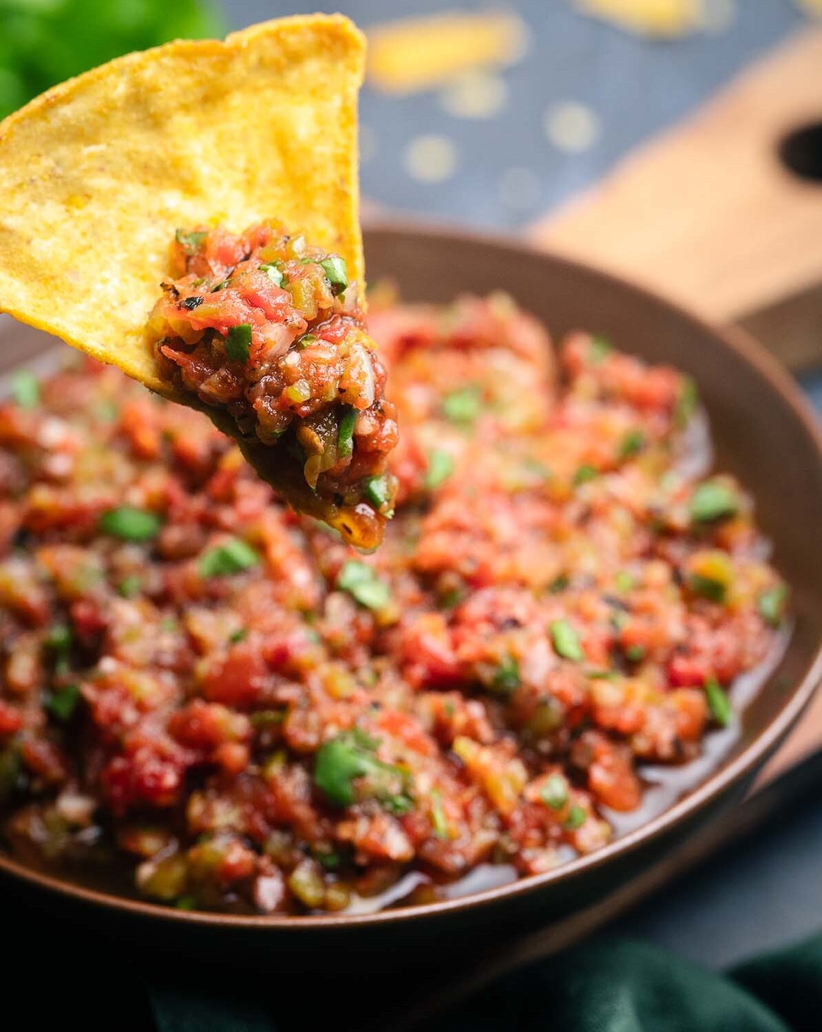 Fire Roasted Salsa scooped on a yellow corn tortilla chip.