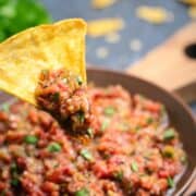 Fire Roasted Salsa scooped on a yellow corn tortilla chip.