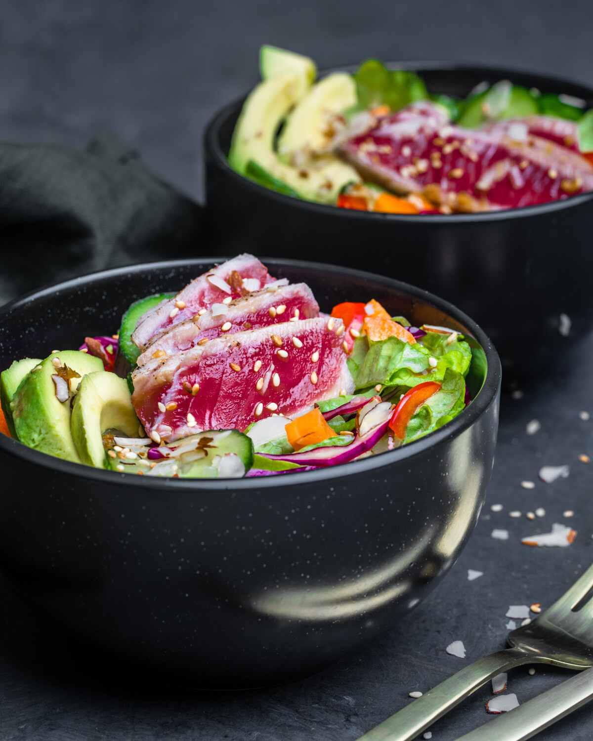 Ahi Tuna Salad served in a black bowl and photographed at an angle.