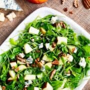 Apple Pecan Salad served on a speckled white platter.