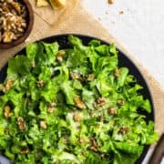 Bibb Lettuce Salad served on a black plate and photographed from the top.