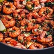 Close up angle shot of Blackened Shrimp in a large skillet.