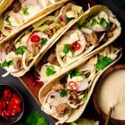 Ground Pork Tacos served on a wooden board and photographed from the top.